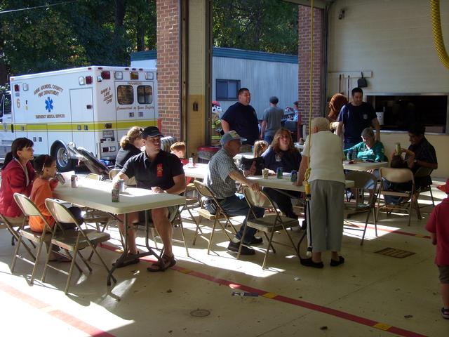 Guests enjoying hot dogs, snacks and drinks at the 2010 Open House